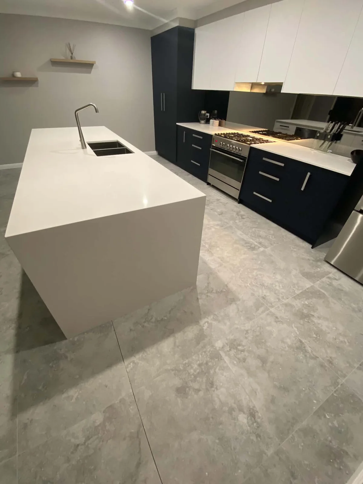 Kitchen with large-format grey floor tiles